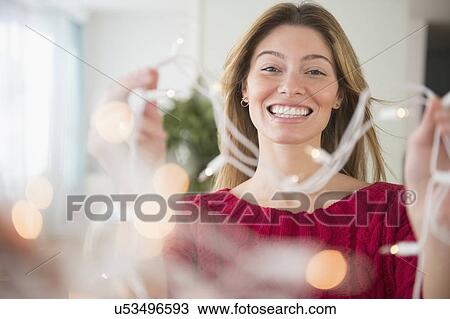 Stock Image - Young woman holding ribbons. Fotosearch
