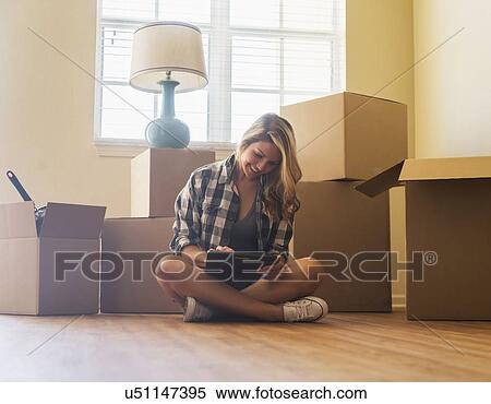 Stock Photography - Young woman in her new house. Fotosearch