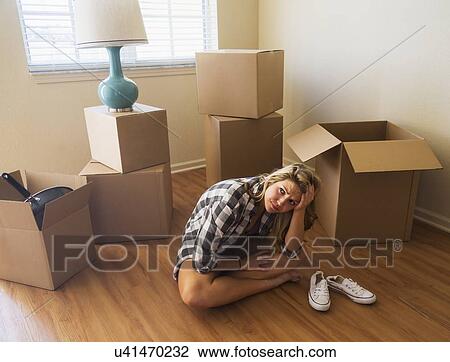 Stock Image - Young woman in new house. Fotosearch
