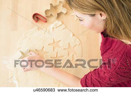 Young woman making coockies at christmas View Large Photo Image Stock Image - Young woman making coockies at christmas. Fotosearch