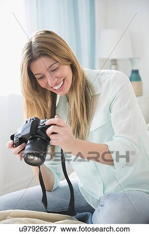 Young woman photographing View Large Photo Image Stock Photo - Young woman photographing. Fotosearch