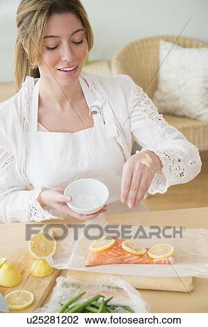 Young woman seasoning salmon View Large Photo Image Stock Image - Young woman seasoning salmon. Fotosearch