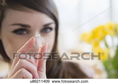 Stock Photo - Young woman showing engagement ring . Fotosearch