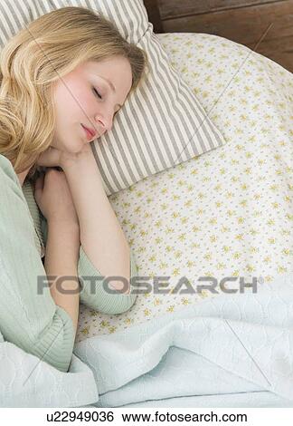 Young woman sleeping in bed View Large Photo Image Stock Photograph - Young woman sleeping in bed. Fotosearch