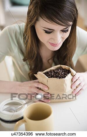Young woman smelling coffee beans View Large Photo Image Stock Photograph - Young woman smelling coffee beans. Fotosearch