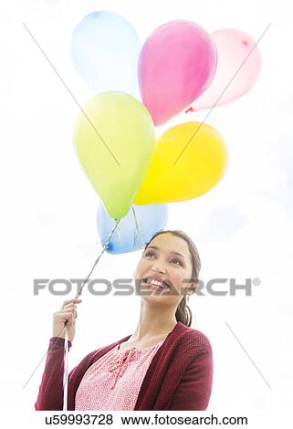 Young woman with colorful balloons View Large Photo Image Stock Photo - Young woman with colorful balloons. Fotosearch