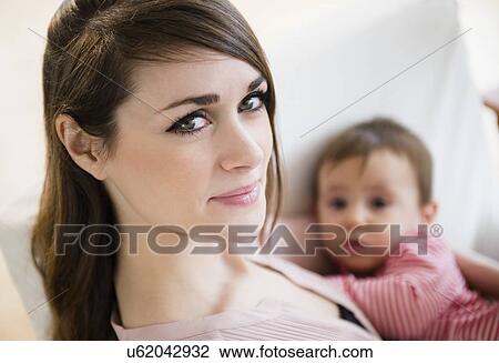 Young woman with daughter(6-11 months) View Large Photo Image Stock Image - Young woman with daughter(6-11 months). Fotosearch