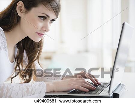 Young woman with laptop View Large Photo Image Stock Image - Young woman with laptop. Fotosearch