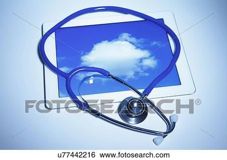 Stock Photograph - Acoustic stethoscope and digital tablet displaying a cloud. Fotosearch