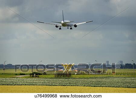 An aeroplane approaching Schiphol Amsterdam Airport View Large Photo Image Stock Photo - An aeroplane approaching Schiphol Amsterdam Airport. Fotosearch