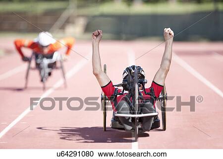 Stock Image - Athlete at finishing line in para-athletic competition. Fotosearch