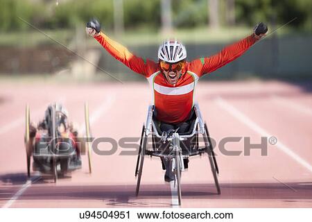 Stock Image - Athlete at finishing line in para-athletic competition. Fotosearch