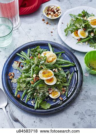 Stock Photo - Bean, coriander, egg and almond salad. Fotosearch