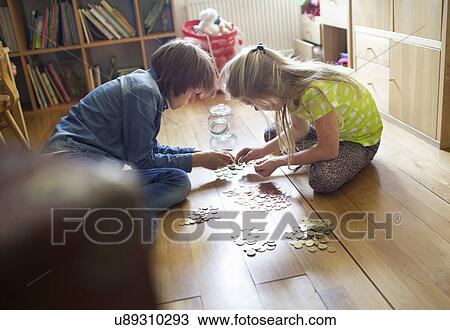 Brother and sister counting coins from savings jar View Large Photo Image Stock Image - Brother and sister counting coins from savings jar. Fotosearch