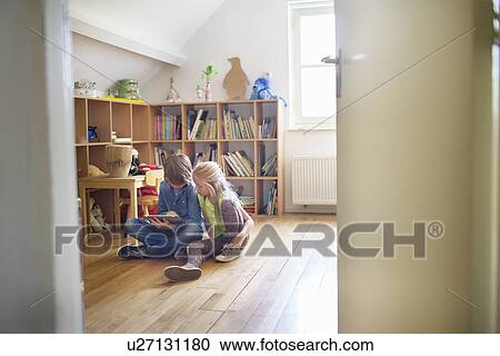 Brother and sister sharing and using digital tablet View Large Photo Image Stock Image - Brother and sister sharing and using digital tablet. Fotosearch