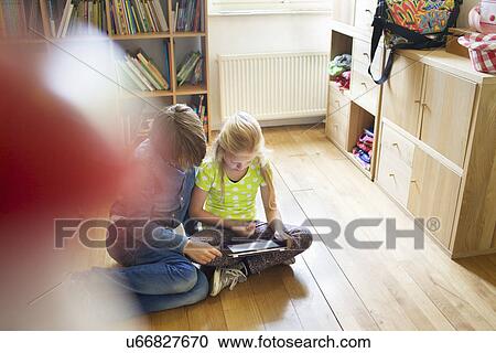 Brother and sister sharing and using digital tablet View Large Photo Image Stock Image - Brother and sister sharing and using digital tablet. Fotosearch