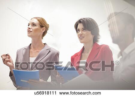 Stock Image - Business colleagues in meeting. Fotosearch
