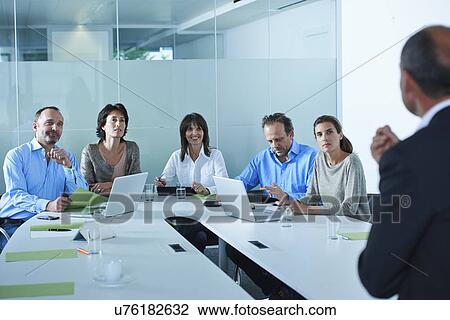 Business team interviewing candidate at boardroom table View Large Photo Image Stock Image - Business team interviewing candidate at boardroom table. Fotosearch