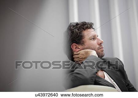 Businessman leaning on elbow View Large Photo Image Stock Image - Businessman leaning on elbow. Fotosearch
