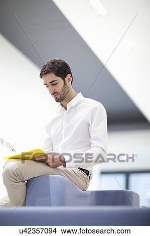 Businessman reading document View Large Photo Image Picture - Businessman reading document. Fotosearch