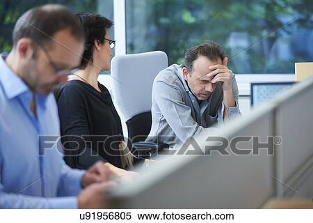 Businesspeople sitting at desk working View Large Photo Image Stock Photography - Businesspeople sitting at desk working. Fotosearch