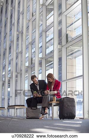 Businesswoman and colleague waiting in conference centre corridor View Large Photo Image Stock Image - Businesswoman and colleague waiting in conference centre corridor. Fotosearch