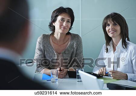 Picture - Businesswomen interviewing candidate in office. Fotosearch