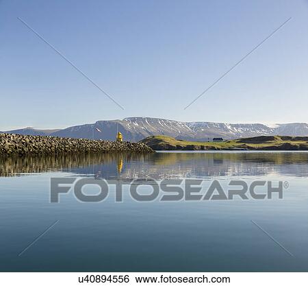 Stock Photograph - Calm sea and harbor wall, Videy, Reykjavik, Iceland. Fotosearch