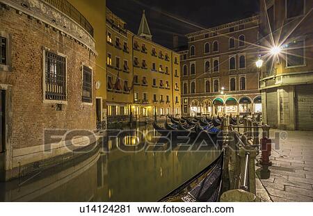 Stock Image - Canal and gondolas at night, Venice, Veneto, Italy. Fotosearch