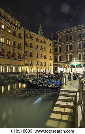 Stock Image - Canal steps and gondolas at night, Venice, Veneto, Italy. Fotosearch