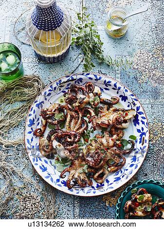 Stock Image - Chargrilled lemon oregano octopus. Fotosearch