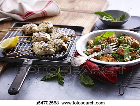 Chargrilled snapper skewers with lemon and bowl of salad View Large Photo Image Stock Photo - Chargrilled snapper skewers with lemon and bowl of salad. Fotosearch