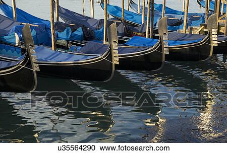 Stock Image - Close up of a row of gondolas on canal, Venice, Veneto, Italy. Fotosearch