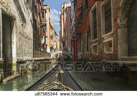 Picture - Close up of part gondola with canal bridge in distance, Venice, Veneto, Italy. Fotosearch