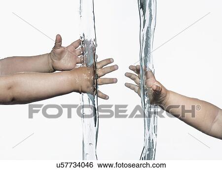 Composite view of toddlers arms and hands reaching out from opposite sides into clear water View Large Photo Image Stock Photograph - Composite view of toddlers arms and hands reaching out from opposite sides into clear water. Fotosearch