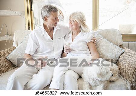 Stock Photo - Couple celebrating in hotel room. Fotosearch