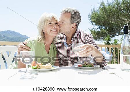 Stock Image - Couple celebrating on holiday, Mallorca, Spain. Fotosearch