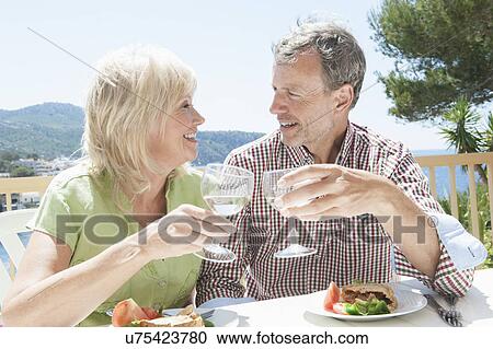 Stock Image - Couple celebrating on holiday, Mallorca, Spain. Fotosearch