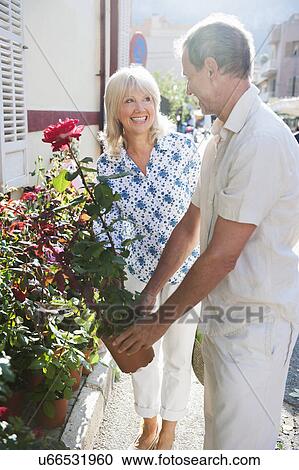 Stock Image - Couple shopping at flower market, Mallorca, Spain. Fotosearch