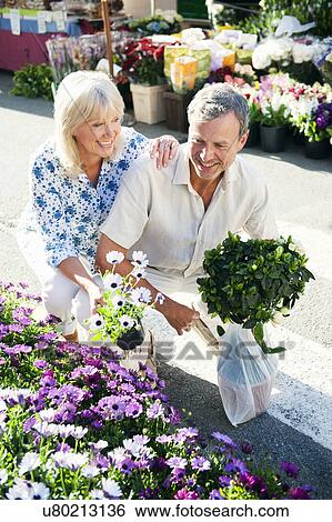Stock Photograph - Couple shopping at flower market, Mallorca, Spain. Fotosearch