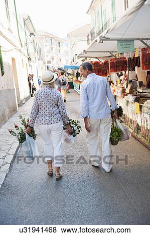 Couple shopping at market, Mallorca, Spain View Large Photo Image Stock Photo - Couple shopping at market, Mallorca, Spain. Fotosearch