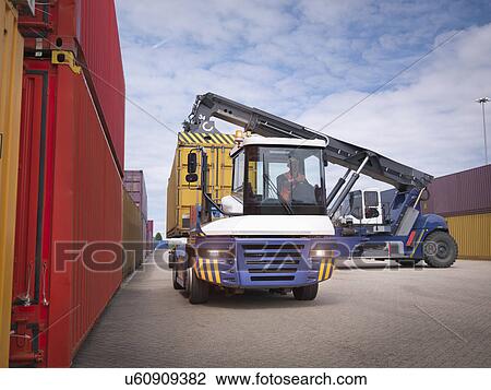 Crane stacking shipping containers from truck in port View Large Photo Image Stock Image - Crane stacking shipping containers from truck in port. Fotosearch