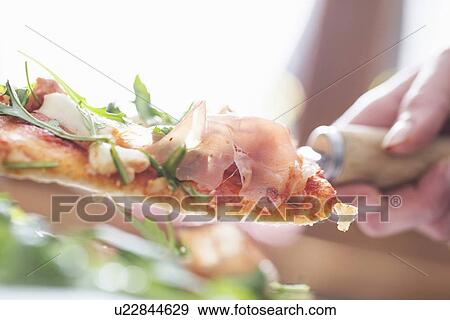 Cropped close up of female hand with pizza slice on spatula View Large Photo Image Stock Photo - Cropped close up of female hand with pizza slice on spatula. Fotosearch