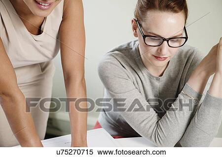 Stock Photography - Cropped shot of two businesswomen in meeting. Fotosearch