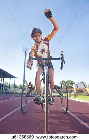 Stock Photo - Cyclist at finishing line in para-athletic competition. Fotosearch