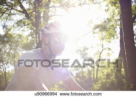 Picture - Cyclist in forest. Fotosearch