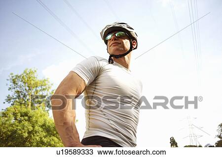 Stock Image - Cyclist stopping for break. Fotosearch