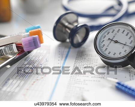 Doctors desk with patients test results, samples, stethoscope and blood pressure gauge View Large Photo Image Picture - Doctors desk with patients test results, samples, stethoscope and blood pressure gauge. Fotosearch