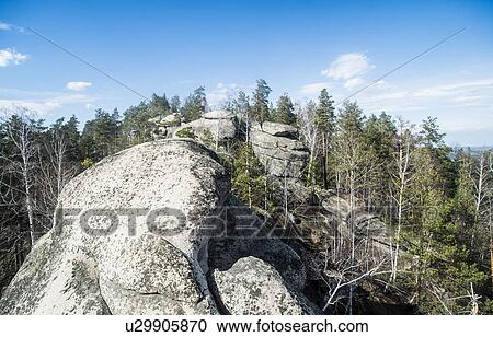 Stock Image - Elevated view of rock formation and forest. Fotosearch