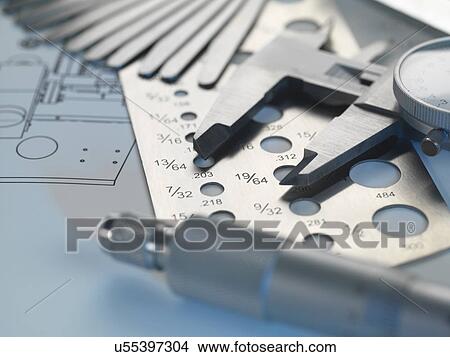 Picture - Engineering design - screw gauge, feeler gauge and micrometer on blueprint. Fotosearch